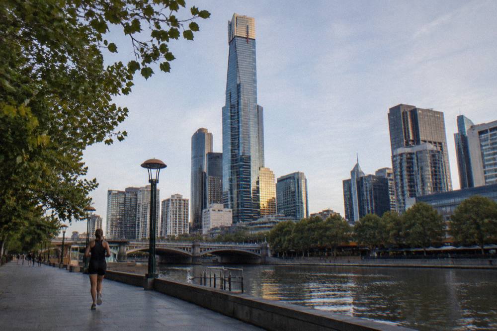 The glass and steel Eureka Tower rising above the Southbank promenade beside the Yarra River