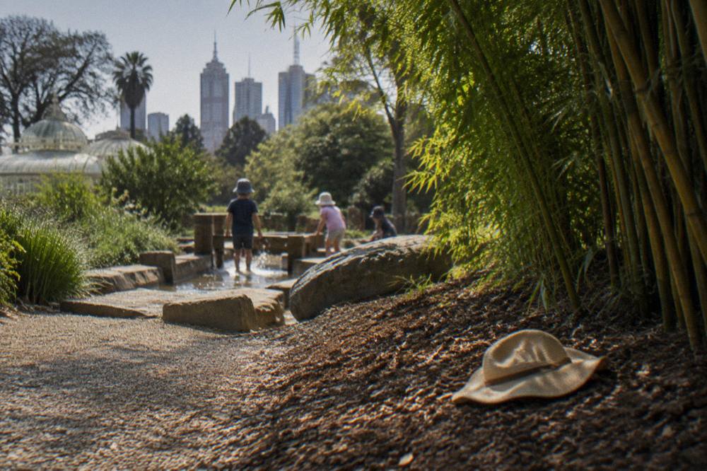 Families walking a gravel path between flower beds in the Royal Botanic Gardens Melbourne