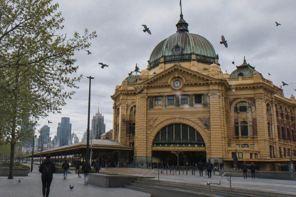 The yellow facade of Flinders Street Station beneath its row of clocks