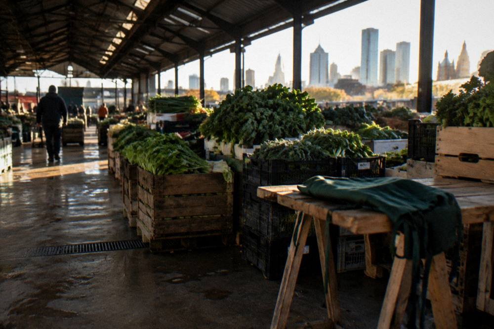 The open-air sheds of Queen Victoria Market filled with fruit and vegetable stalls