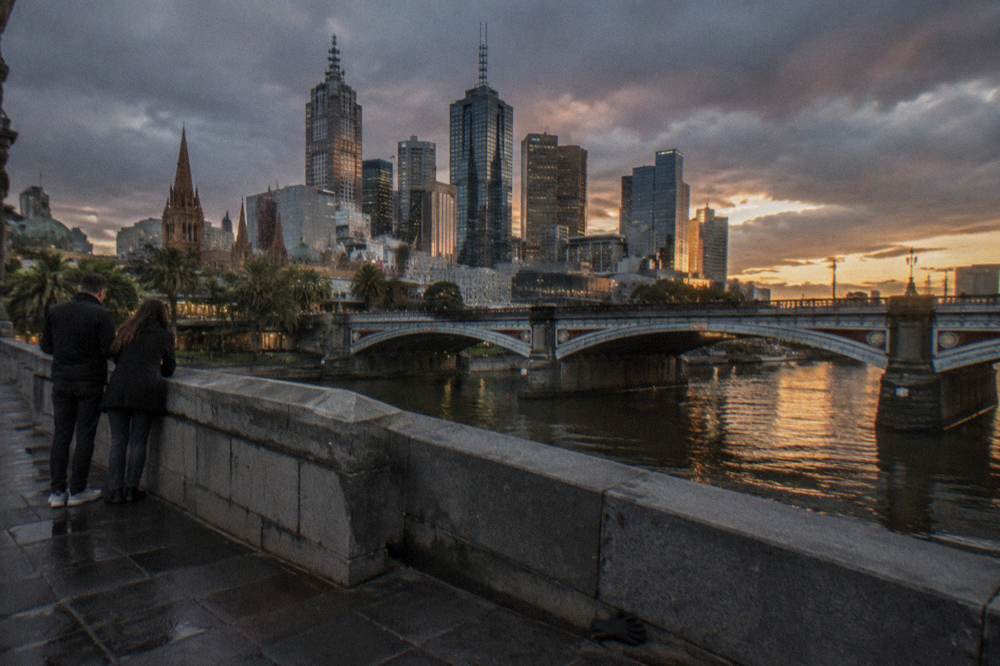 Princes Bridge and the Yarra River at sunset with the city skyline glowing behind